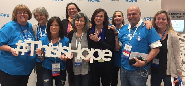 A group of lung cancer survivors together at HOPE Summit holding a sign that says 'This Is Hope'