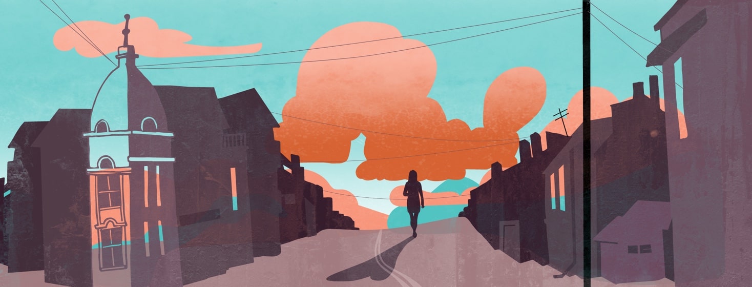 Silhouette of a person walking down an empty road at sunset.