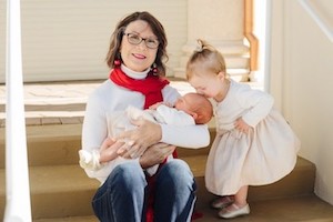 Melissa sitting with her two grandchildren