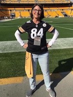 Melissa standing on a football field
