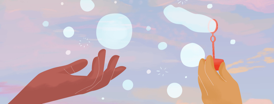 Person reaches for bubbles floating behind a pink, blue, and yellow sky