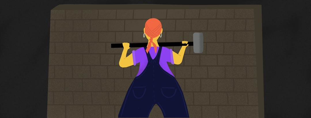 A woman stands before a wall holding a sledgehammer, ready to bust it down