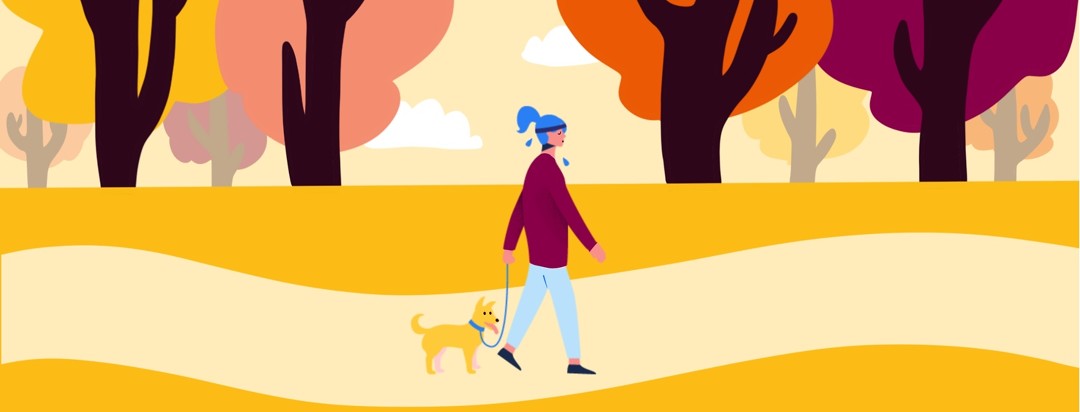 A woman wears a sweatband and sweats while walking her dog in the park