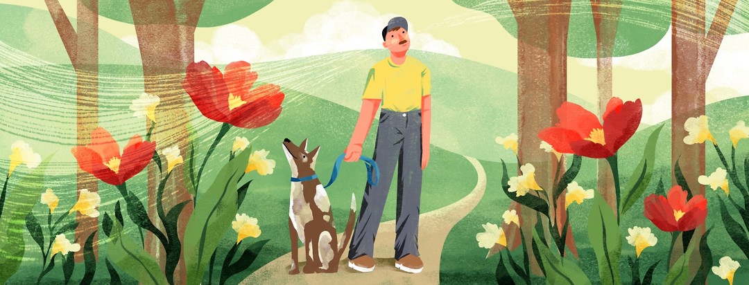 Man walking his dog takes a deep breath, smelling the flowers