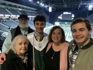 Ivy posing with her family at her son's graduation