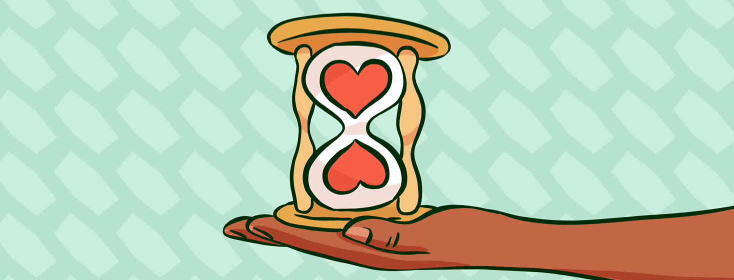 A hand holding an hourglass filled with hearts