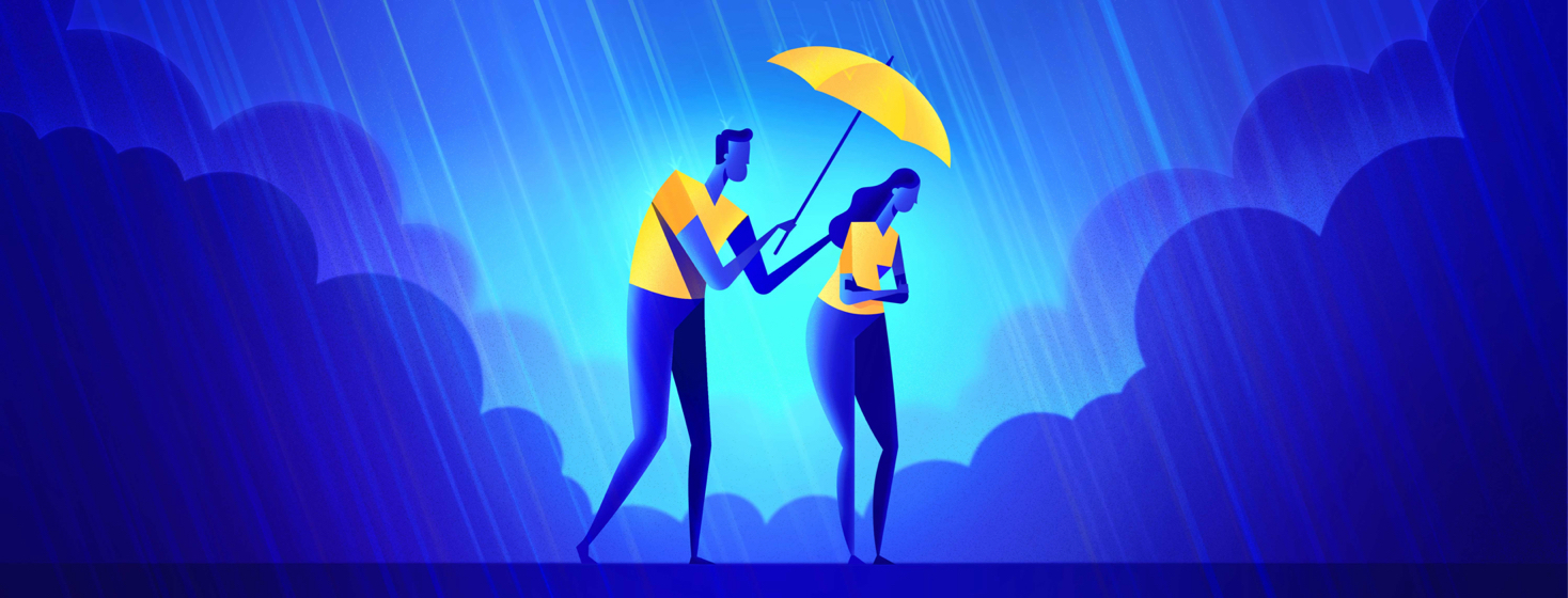 A man holding an umbrella over a woman while it rains