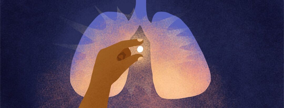 A hand holds a pill emitting a glowing light in front of a silhouette of lungs with a sunrise.