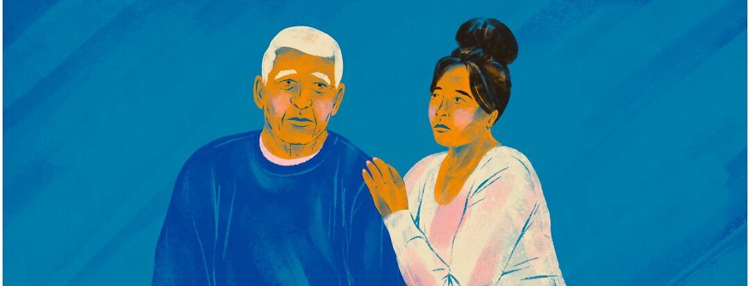 A younger woman has her hand on the shoulder of an older man.